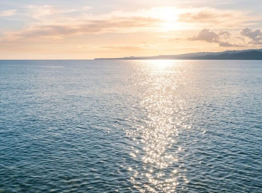 Sunlight reflecting on calm ocean water at sunset, cremation services in Apache Junction, AZ