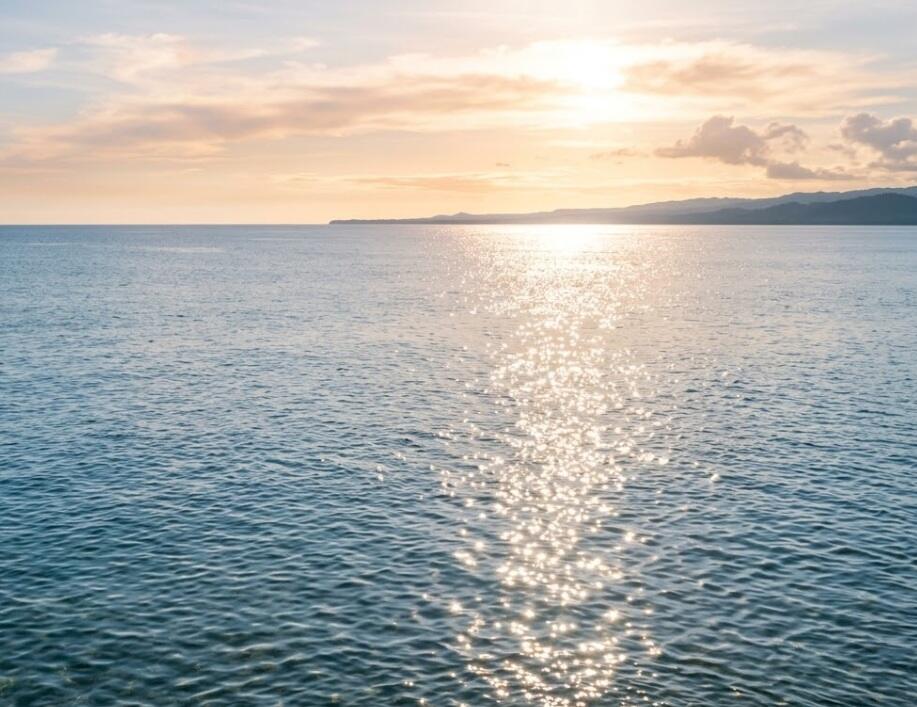Sunlight reflecting on calm ocean water at sunset, cremation services in Apache Junction, AZ
