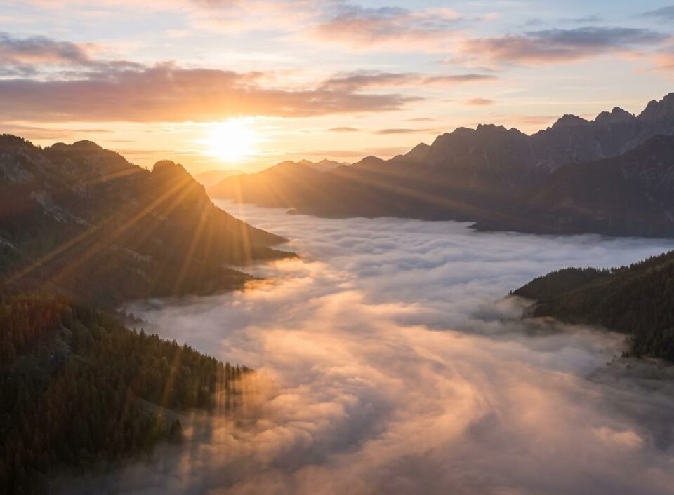 Sunrise over mountains above clouds, cremation services in Gilbert, AZ